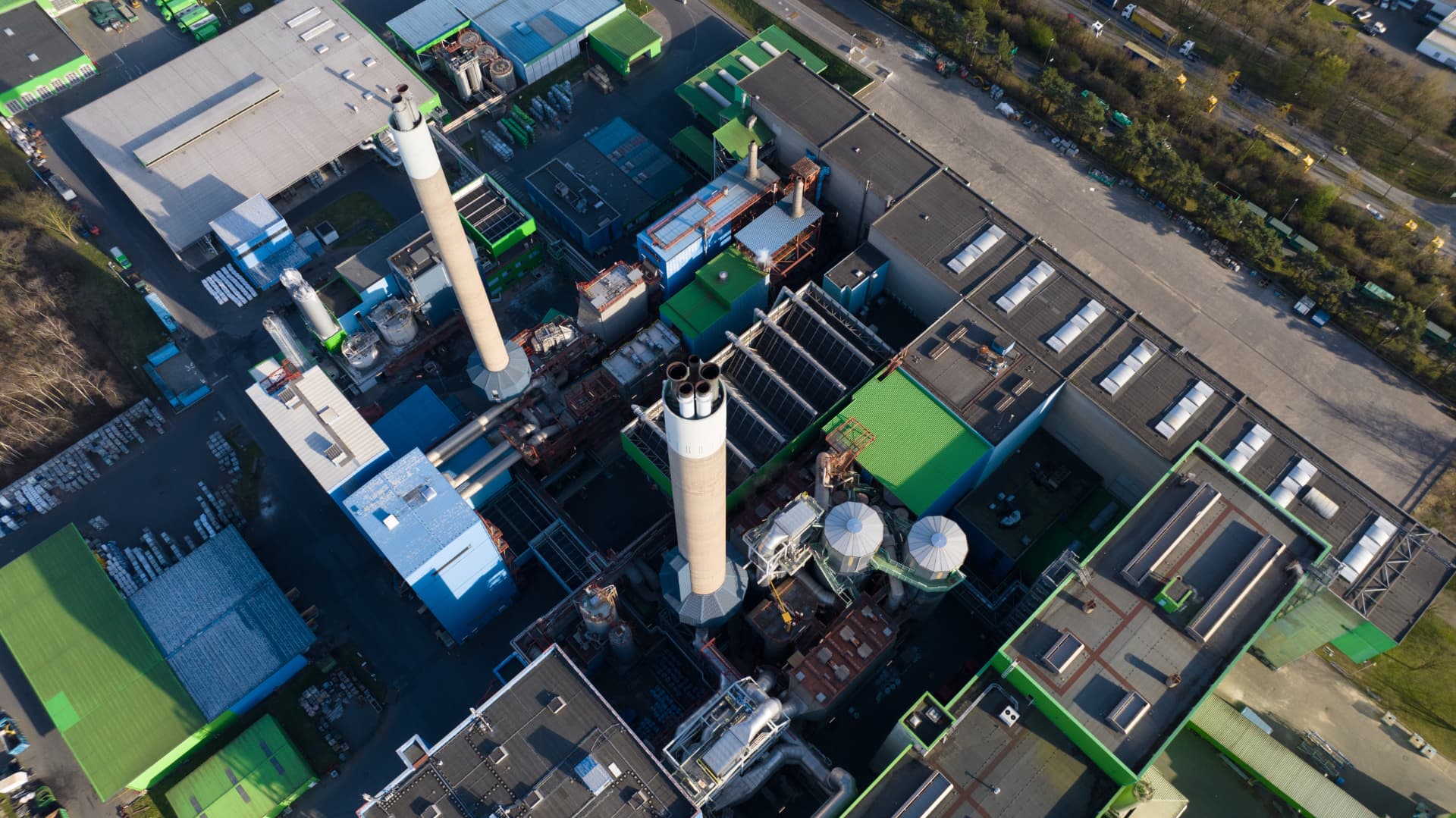 Aerial view of an industrial treatment facility with process equipment and chimneys